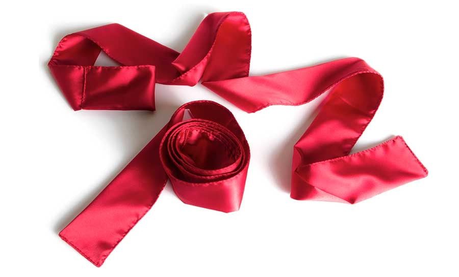 Red satin ribbon-style tie-up restraints laid flat