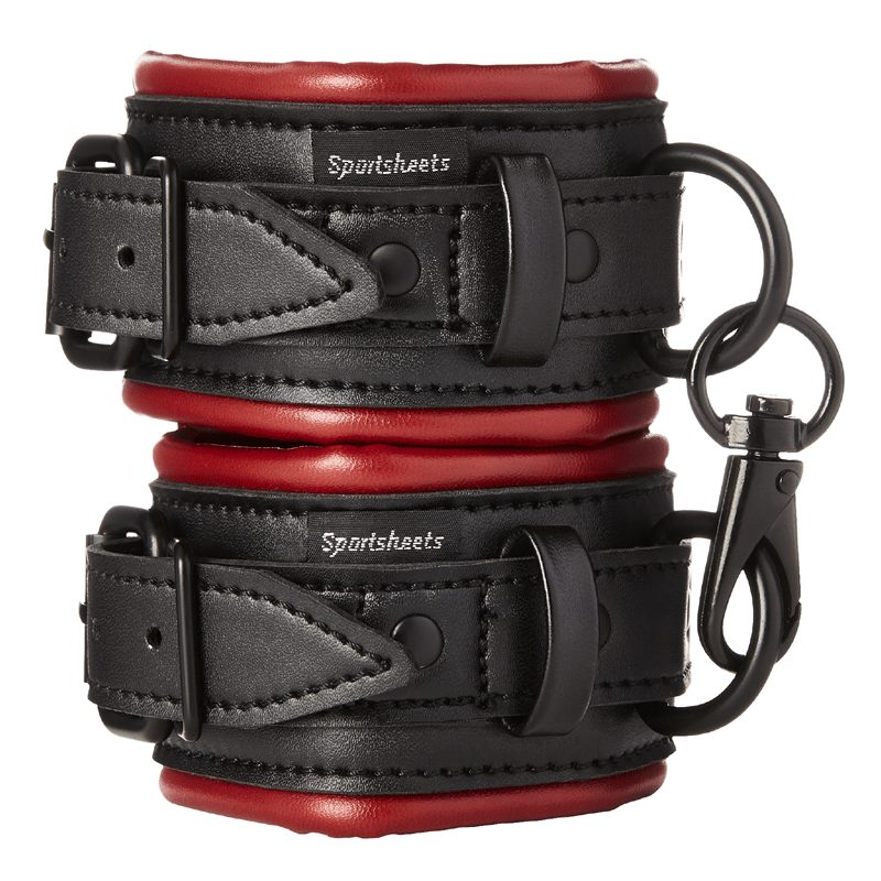 A pair of scarlet and black vegan leather wrist cuffs with soft lining, linked together